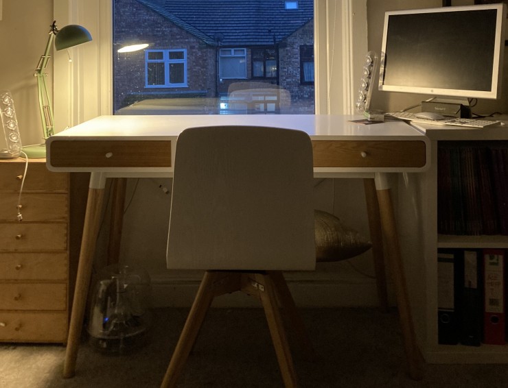 A chair, a desk and a window