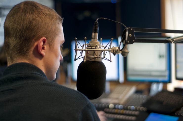 Young man makes a radio broadcast