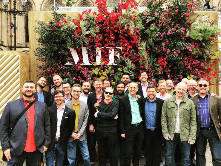 Choir standing under MIF flower wall